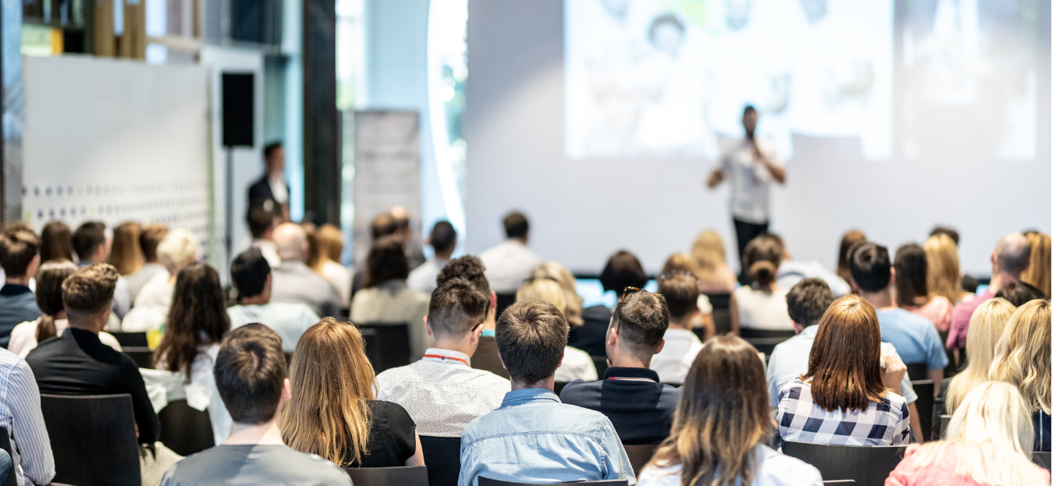 People sitting in a conference room during a presentation.